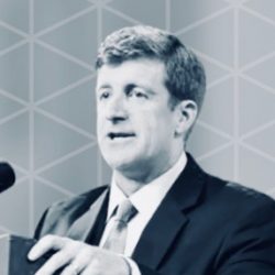 Patrick J. Kennedy speaking at a podium